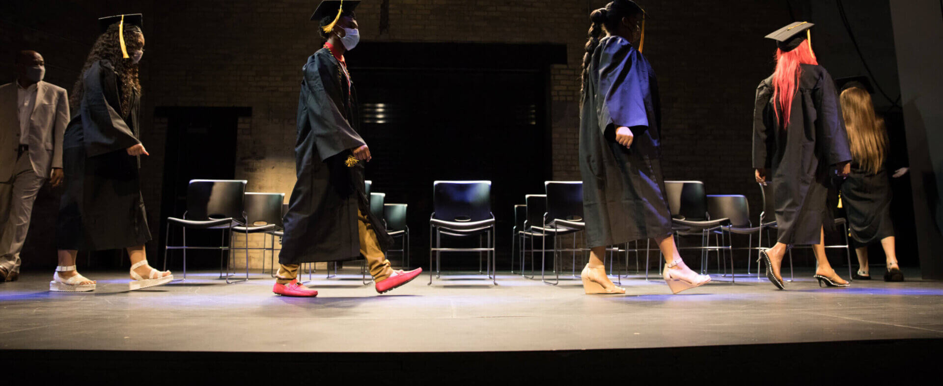 graduates walking across stage